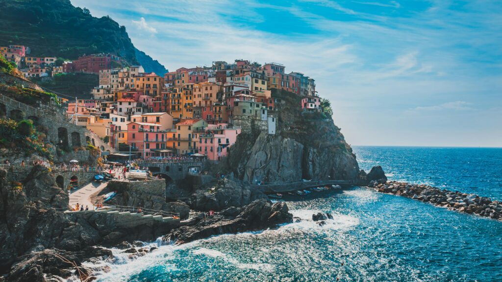 Vibrant houses on a cliff overlooking the ocean in Cinque Terre, Italy. Stunning coastal scenery.